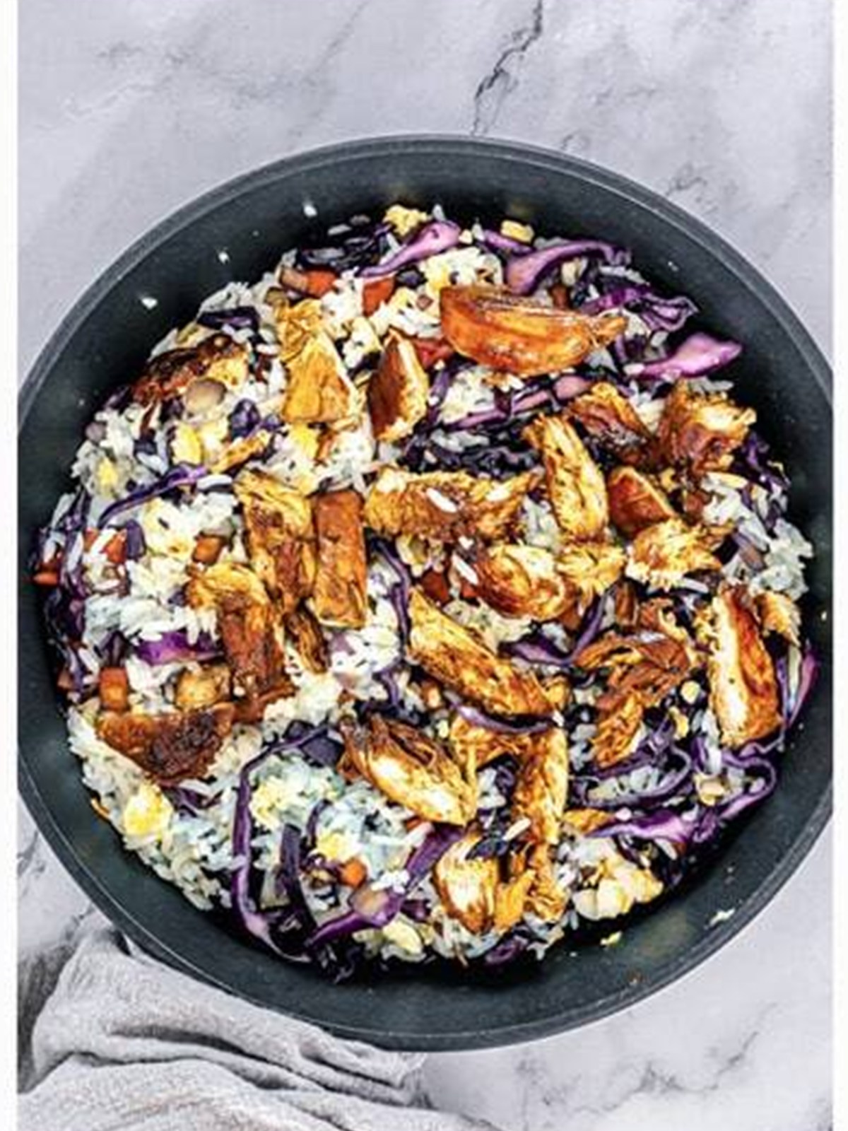 Vegetables, diced teriyaki chicken, and teriyaki sauce stirred into the fried rice.