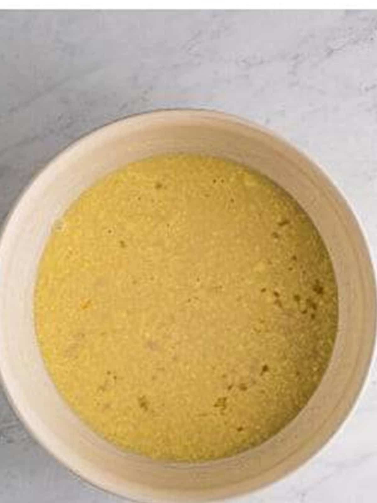 Whisked together milk, melted butter, honey, salt, and egg in a bowl.