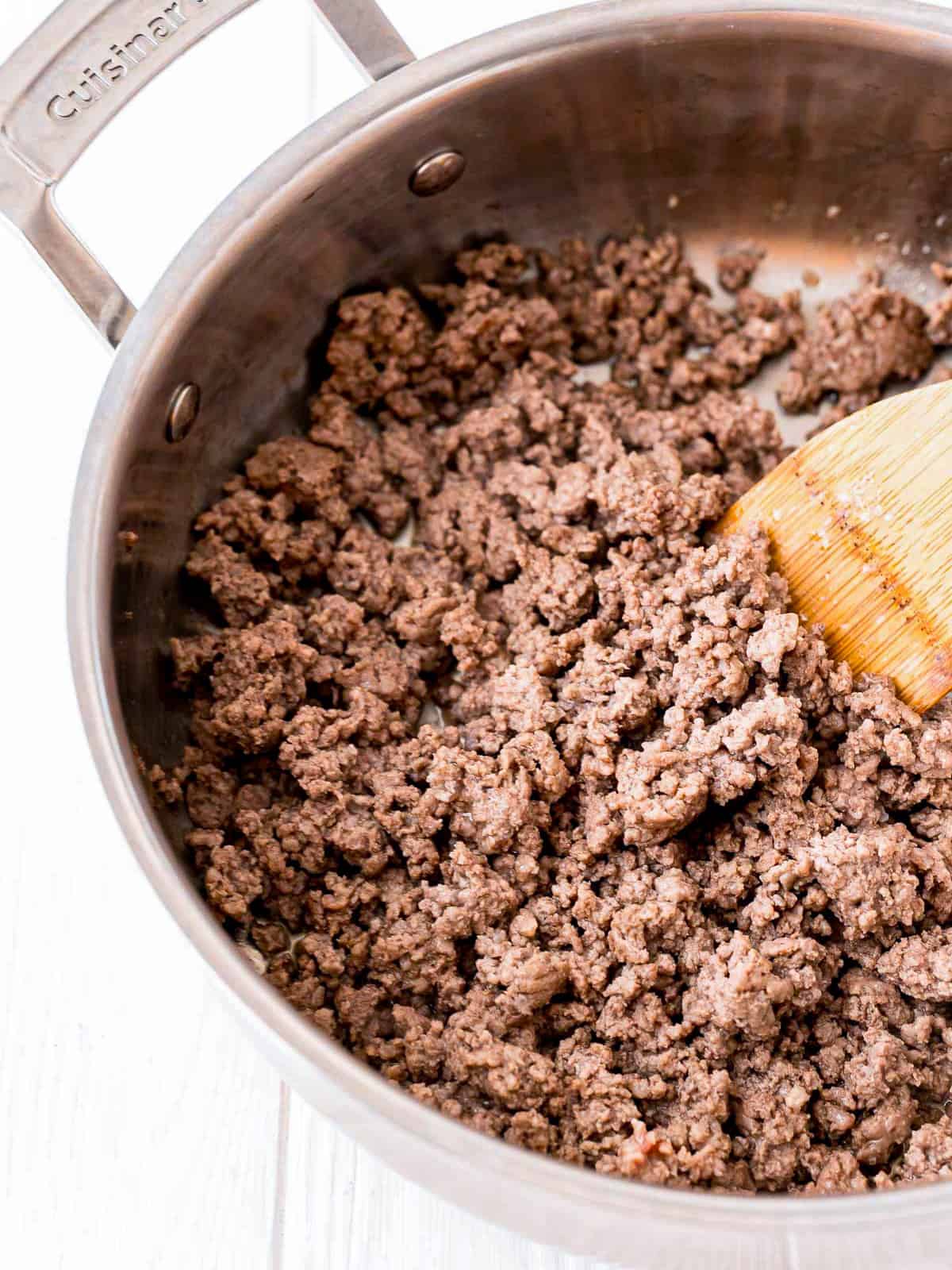 Browned ground beef in a skillet for Thai beef bowls.