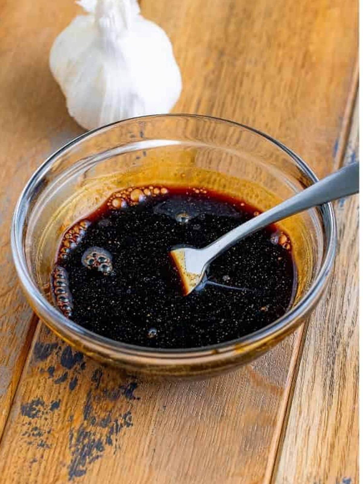 Pad see ew sauce stirred together in a bowl with soy sauce, oyster sauce, and rice vinegar.