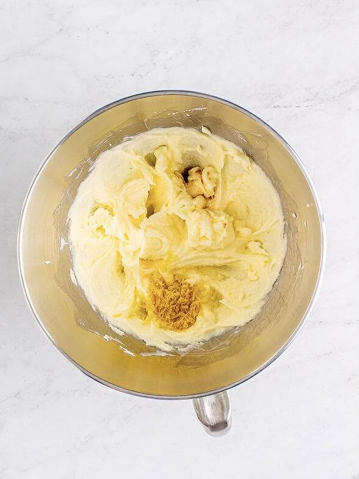Egg yolk and vanilla added to the creamed butter for thumbprint cookie dough.
