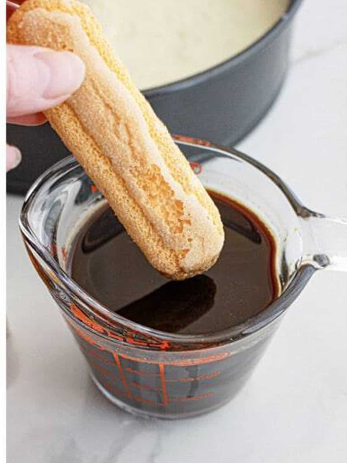 A lady finger cookie dipped in brewed espresso for tiramisu cheesecake.