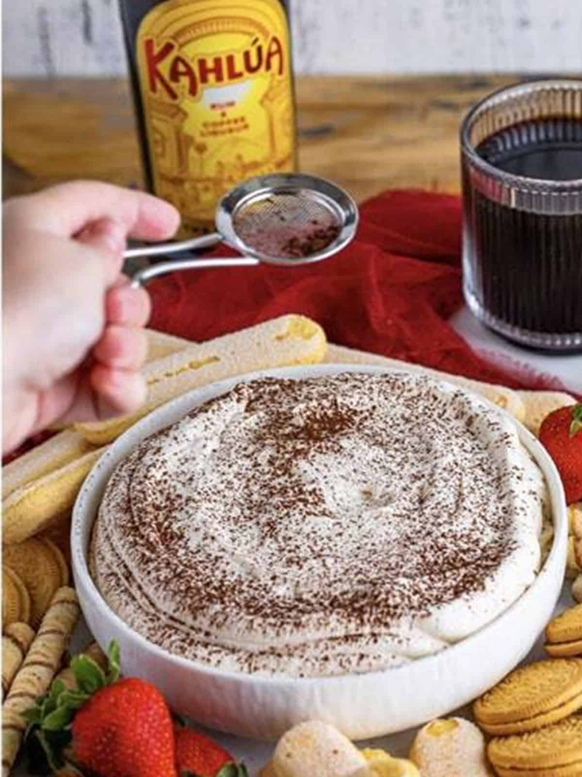 Finished tiramisu dip dusted with cocoa powder and served with cookies.