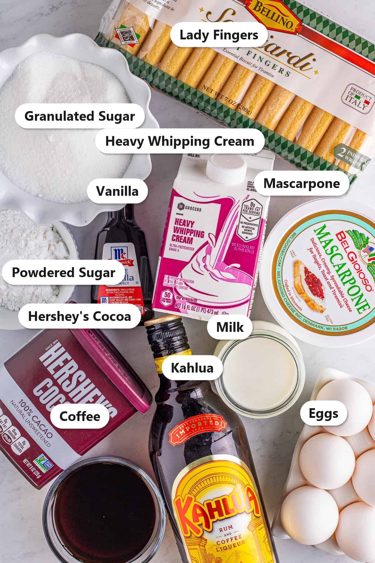 Labeled tiramisu recipe ingredients including lady fingers, mascarpone, heavy whipping cream, Kahlua, eggs, and cocoa.