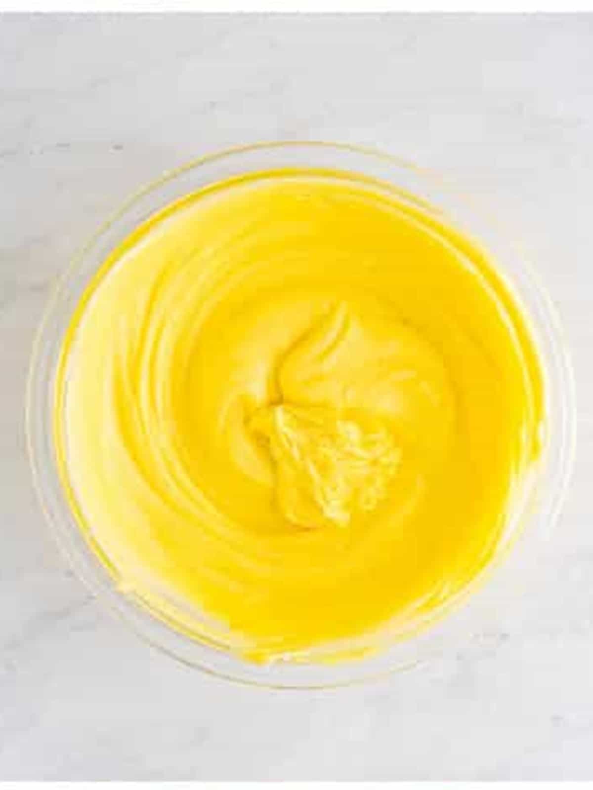 Whisking mascarpone and custard smooth for tiramisu recipe.