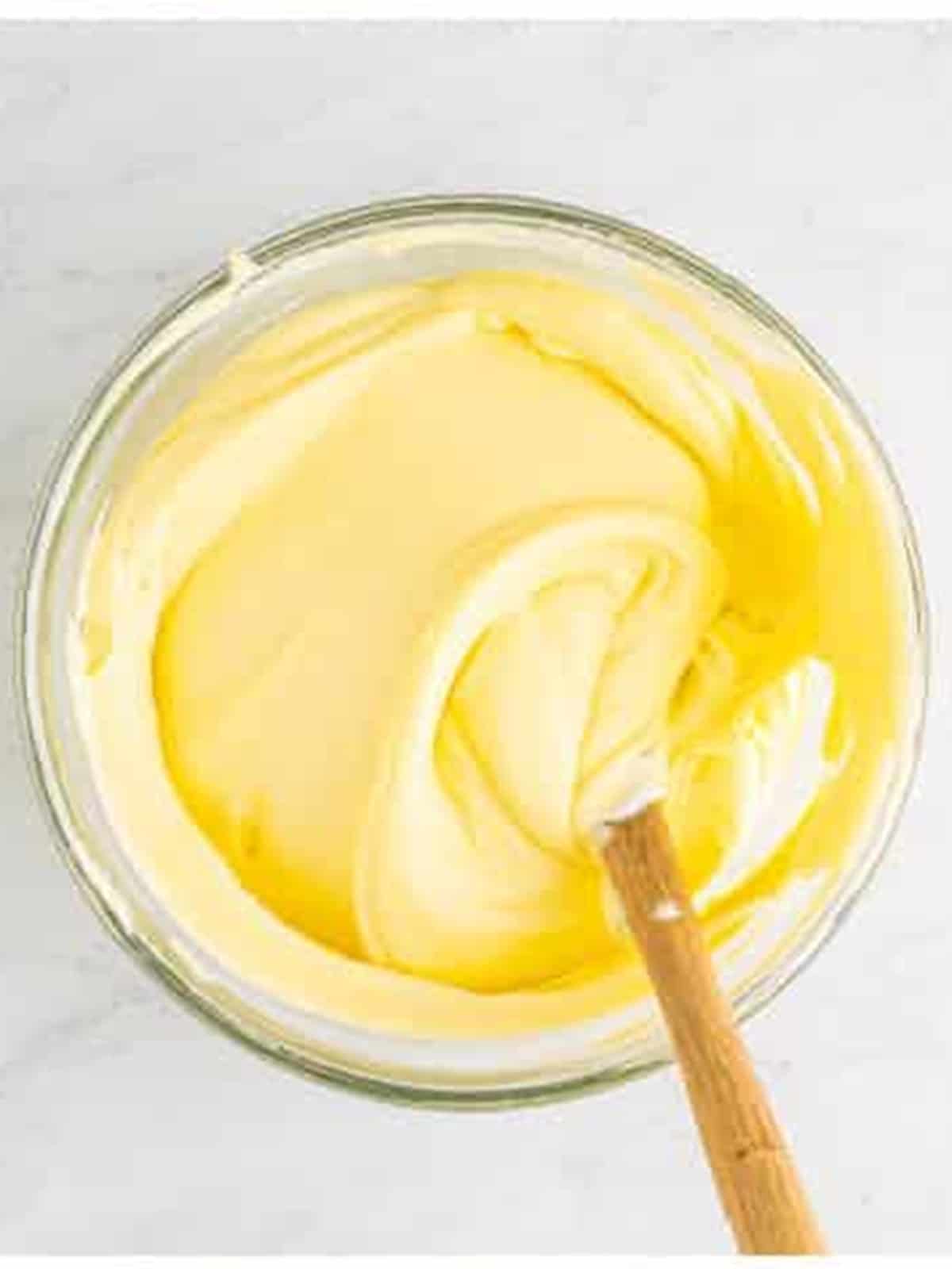 Folding whipped cream into the mascarpone mixture for tiramisu recipe.