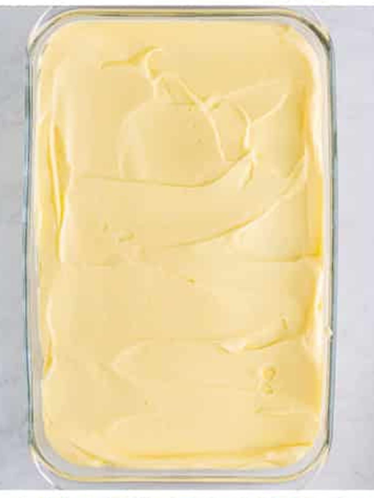 Spreading the first cream layer over lady fingers for tiramisu recipe.