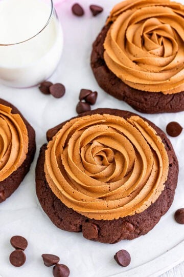 A triple chocolate cookie topped with a swirled chocolate fudge frosting rosette.