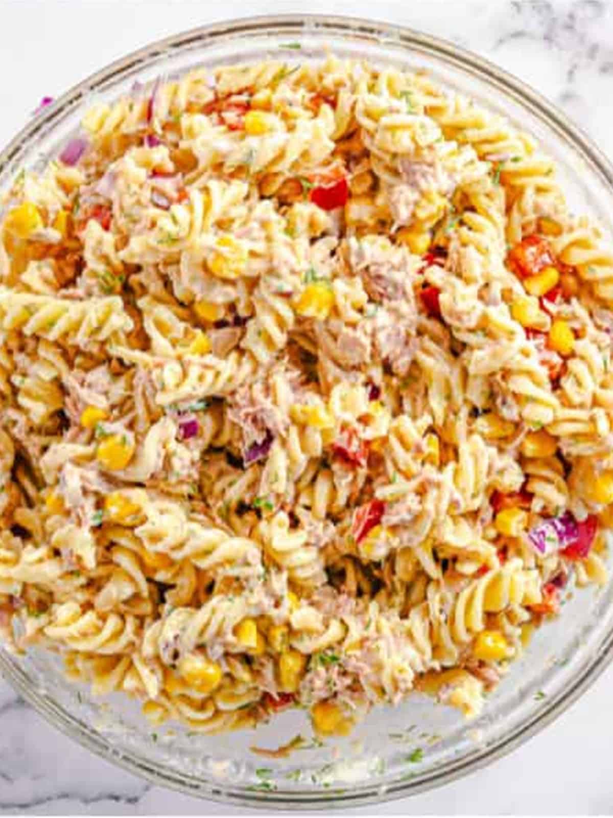 The tuna pasta salad tossed in creamy dressing and ready to chill.