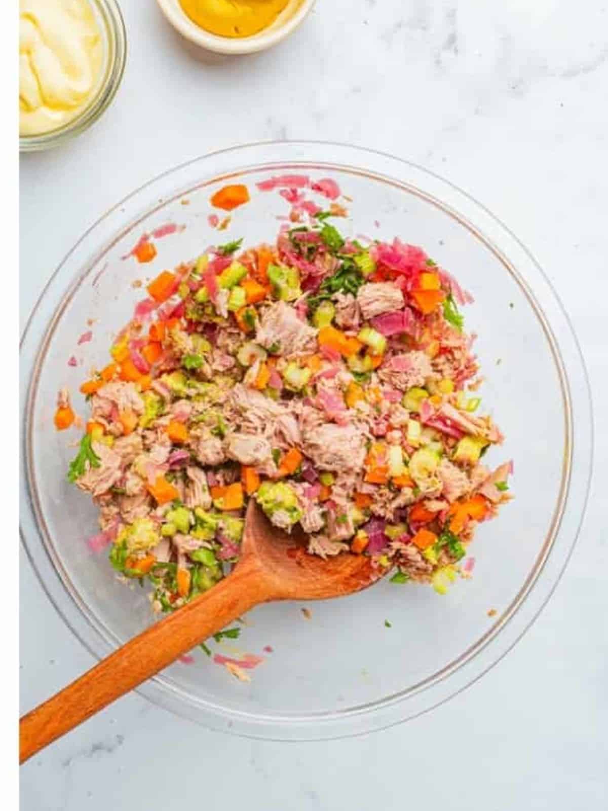 Stirring the Tuna Salad together until evenly combined.