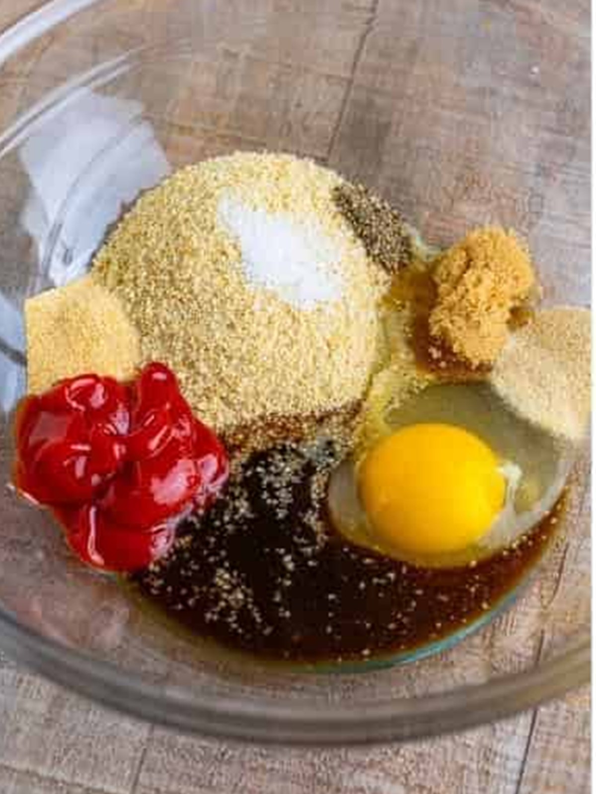 Ketchup, Worcestershire, brown sugar, spices, breadcrumbs, and an egg in a bowl for turkey burgers.