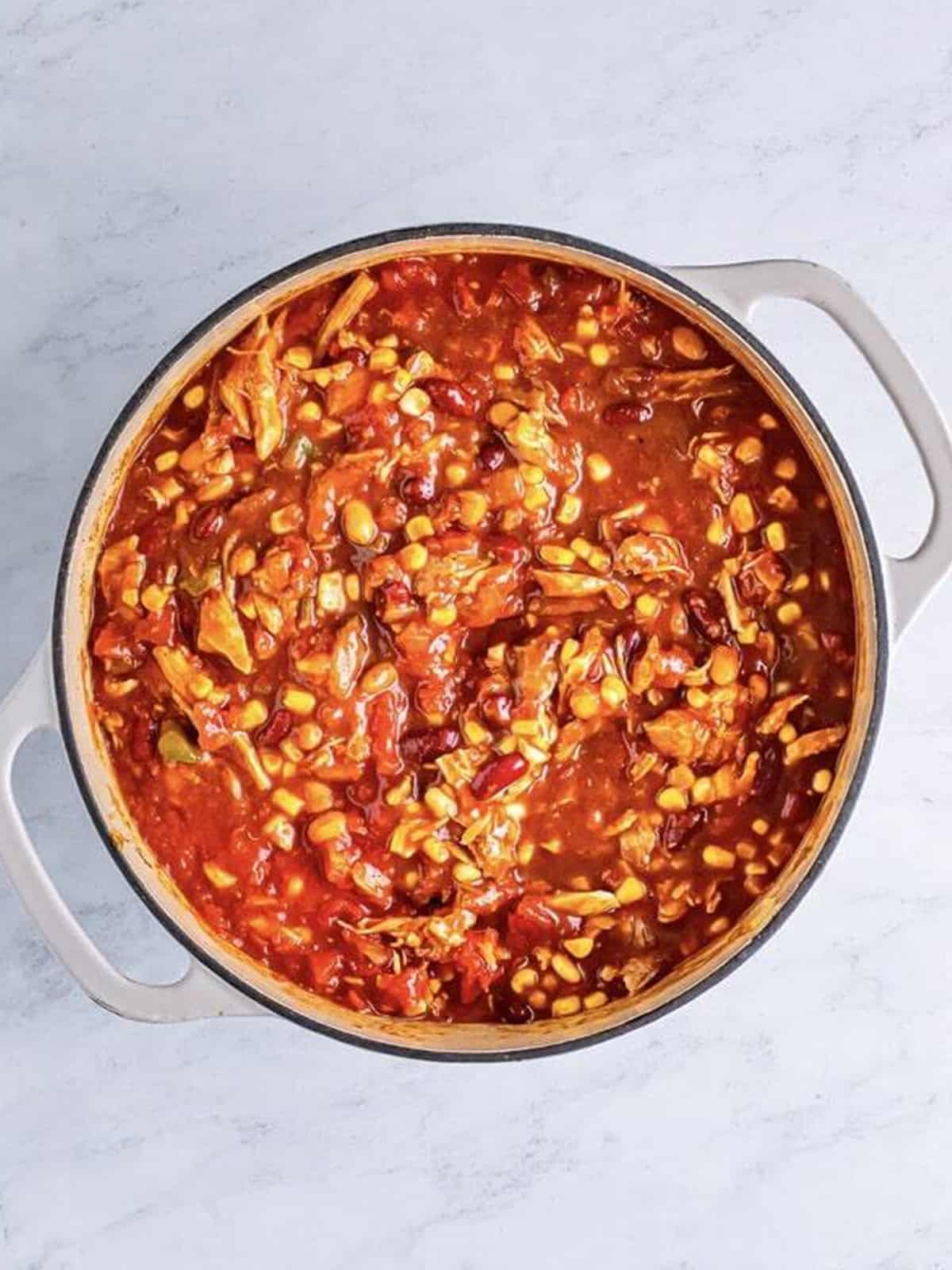 Crushed tomatoes, beans, and corn stirred into the turkey chili.