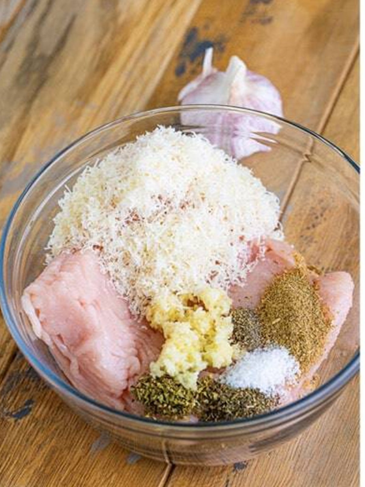 Ground turkey, herbs, garlic, fennel, and parmesan combined in a bowl.