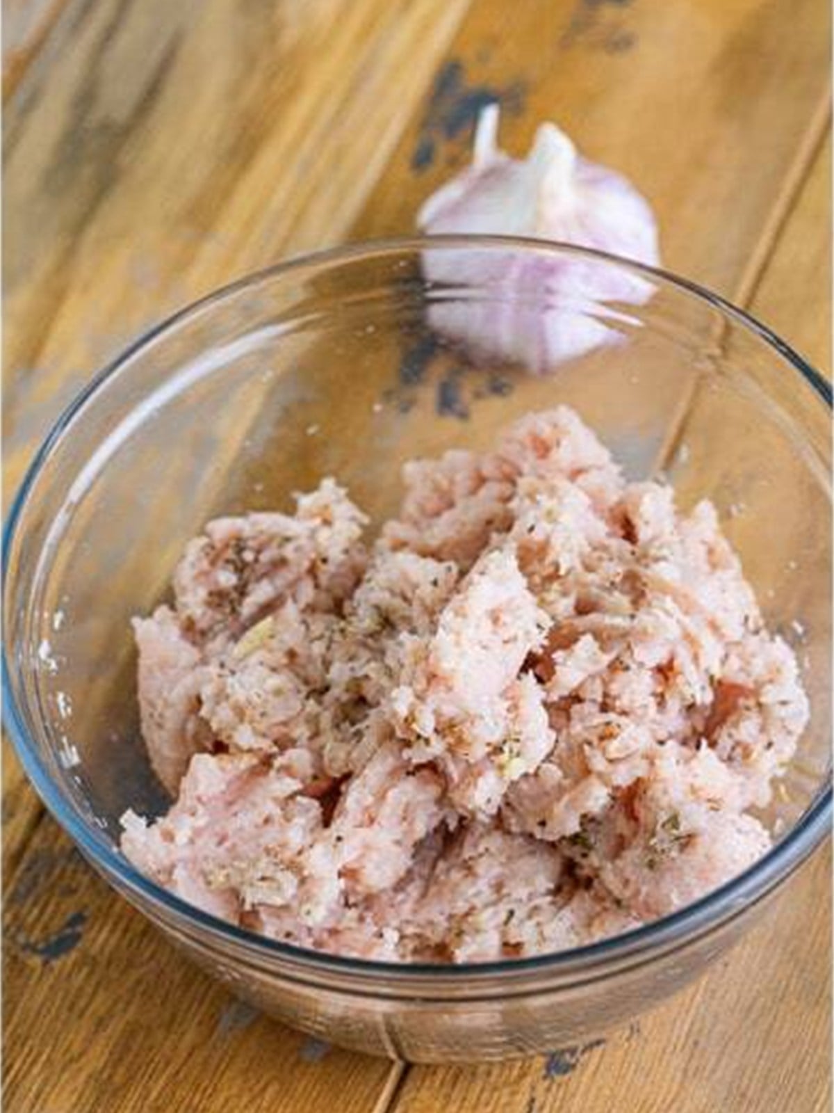 Seasoned ground turkey mixture combined in a glass bowl.