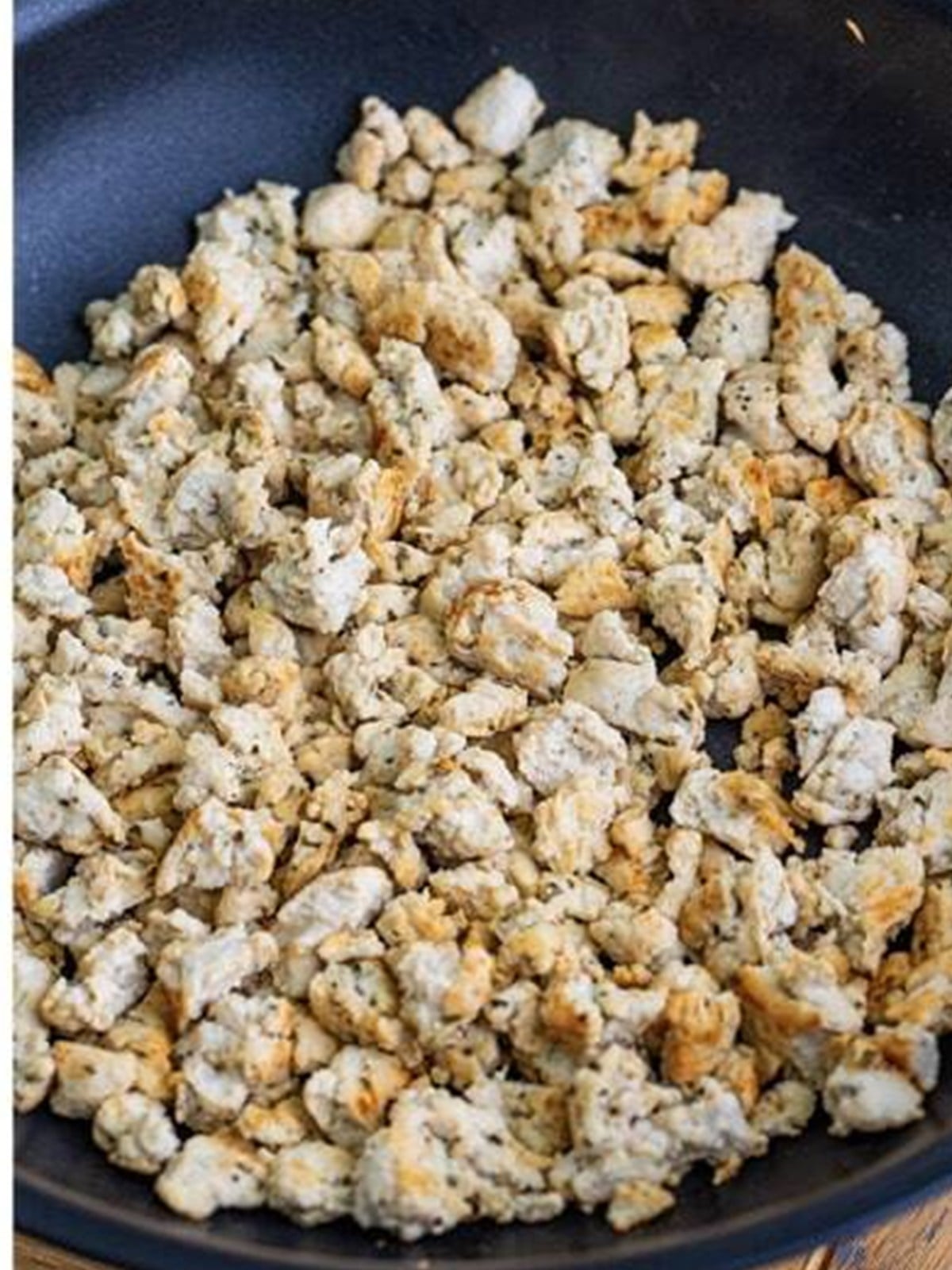 Ground turkey browned and crumbled in a skillet.