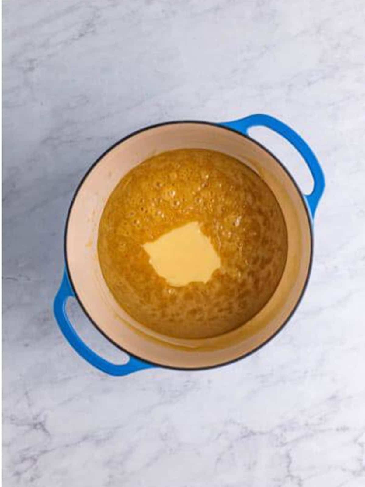 Sweetened condensed milk being cooked into the caramel mixture.