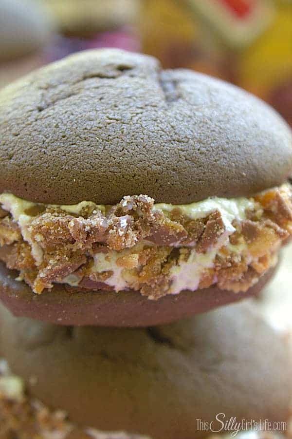 A single twix whoopie pie showing the soft chocolate cookies and marshmallow filling.
