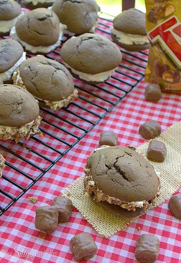 Chocolate whoopie pies filled with fluffy marshmallow cream and Twix candy bits.
