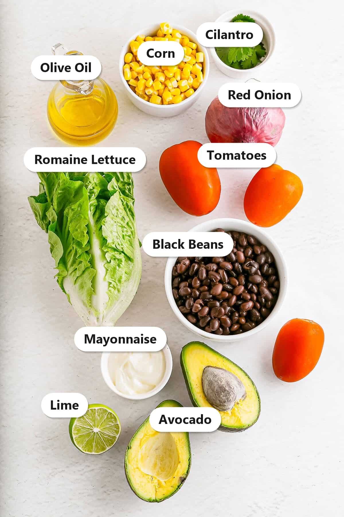 Labeled ingredients for vegetarian lettuce wraps including black beans, corn, avocado, tomatoes, red onion, cilantro, mayonnaise, lime, olive oil, and romaine lettuce.