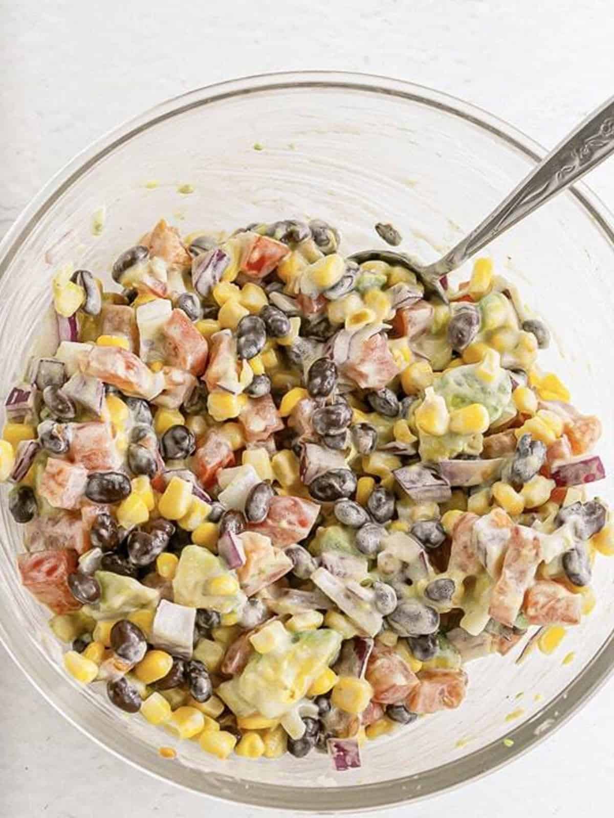 The tossed black bean and corn veggie salad ready to spoon into lettuce leaves.