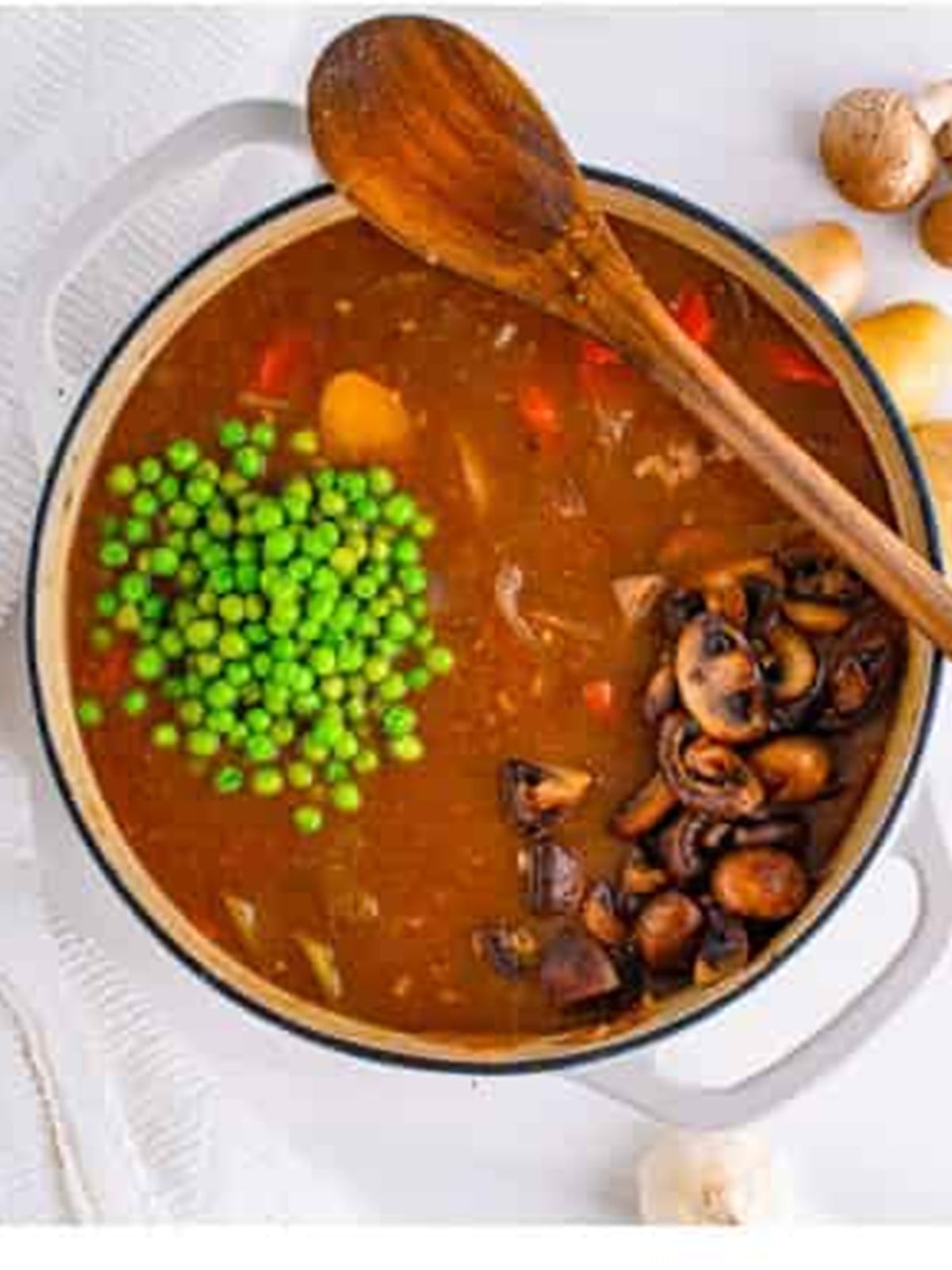 Mushrooms and frozen peas stirred into the finished venison stew.