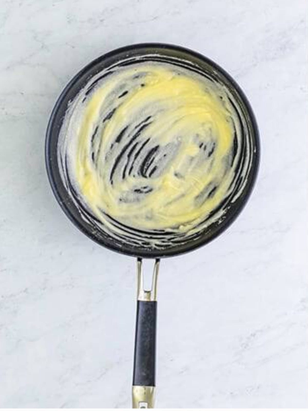 Butter and cornstarch whisked into a roux in a skillet for wet burrito sauce.