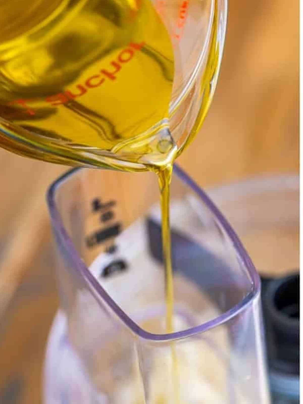 Slowly streaming olive oil into the food processor for creamy Whipped Feta Dip.