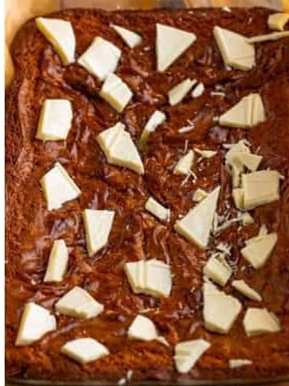 Baked white chocolate brownies topped with chunks of white chocolate.