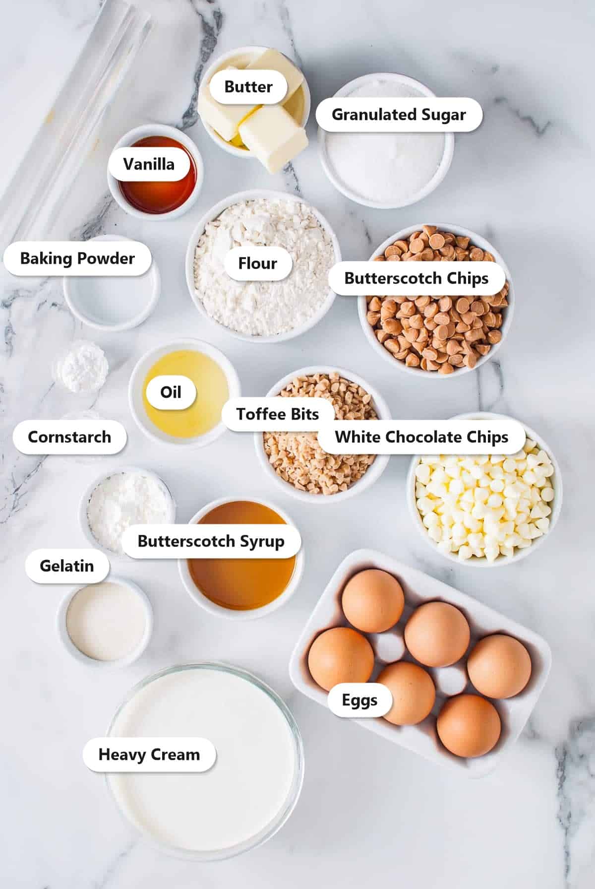 Labeled white chocolate mousse cake ingredients including butterscotch chips, white chocolate chips, toffee bits, eggs, and heavy cream.