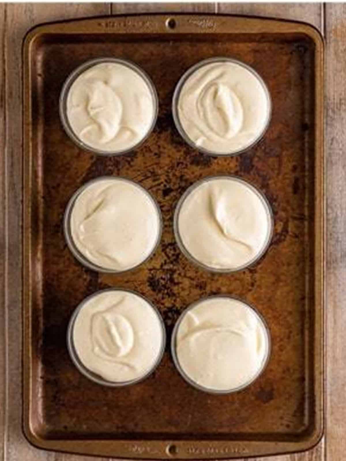 White chocolate mousse piped into serving glasses to chill.