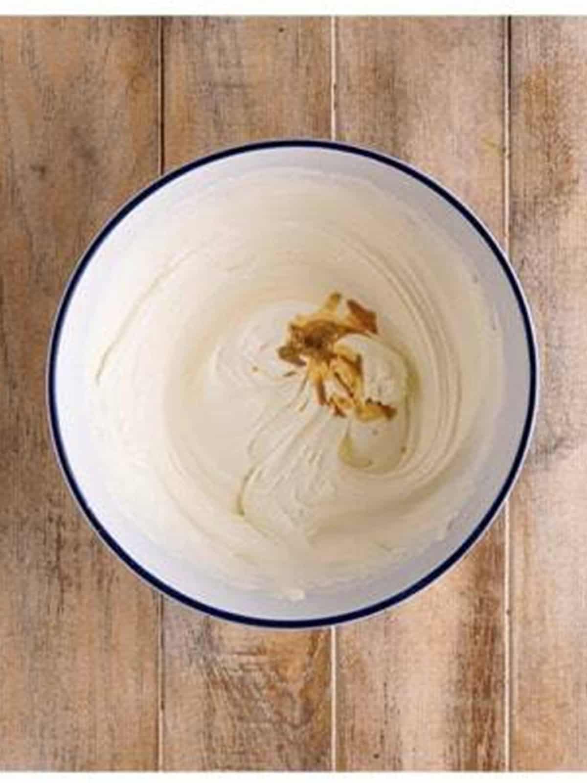 Vanilla added to whipped cream for white chocolate mousse.