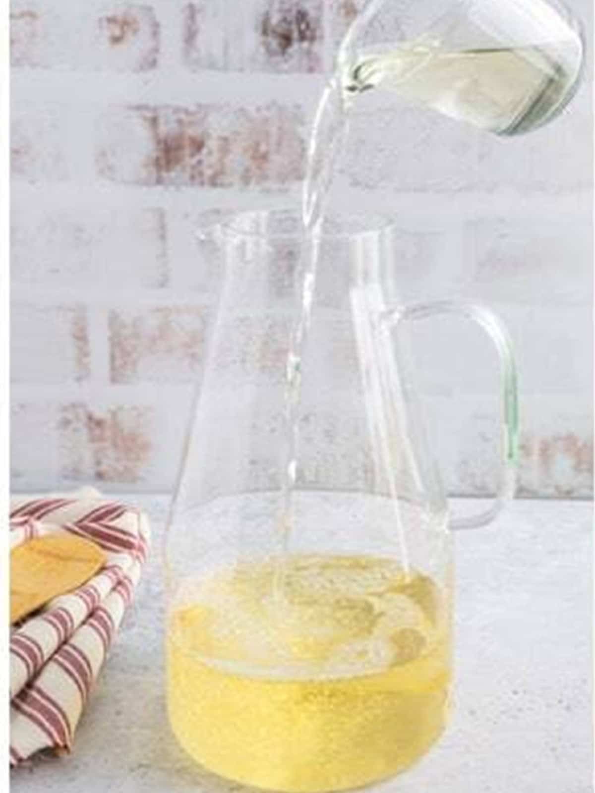 Adding rum to the white wine sangria pitcher.