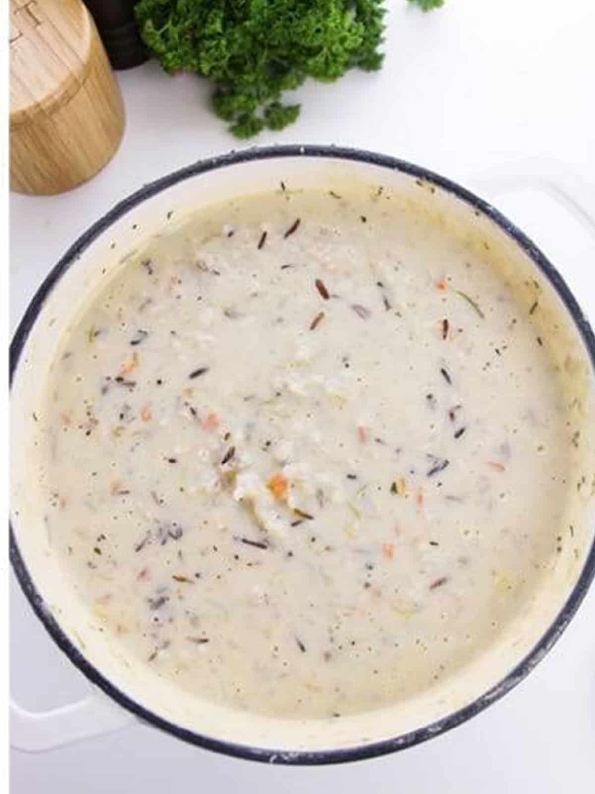 The finished creamy wild rice soup topped with fresh parsley.