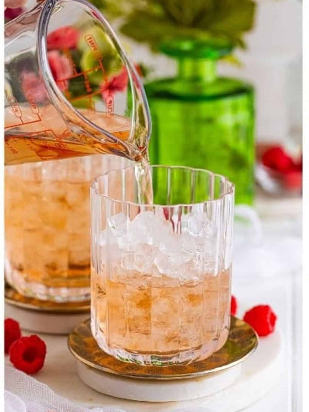 Chilled wine being poured over ice for a wine spritzer.