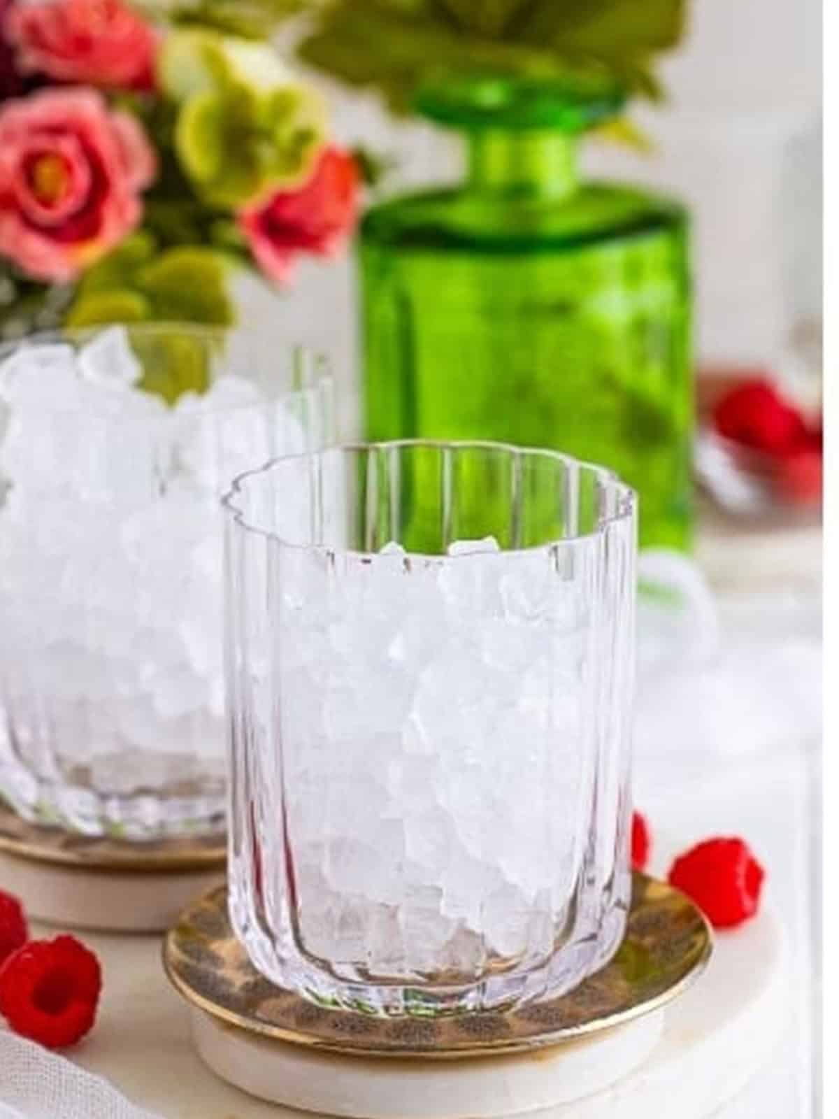 A glass filled three quarters with ice for a wine spritzer.