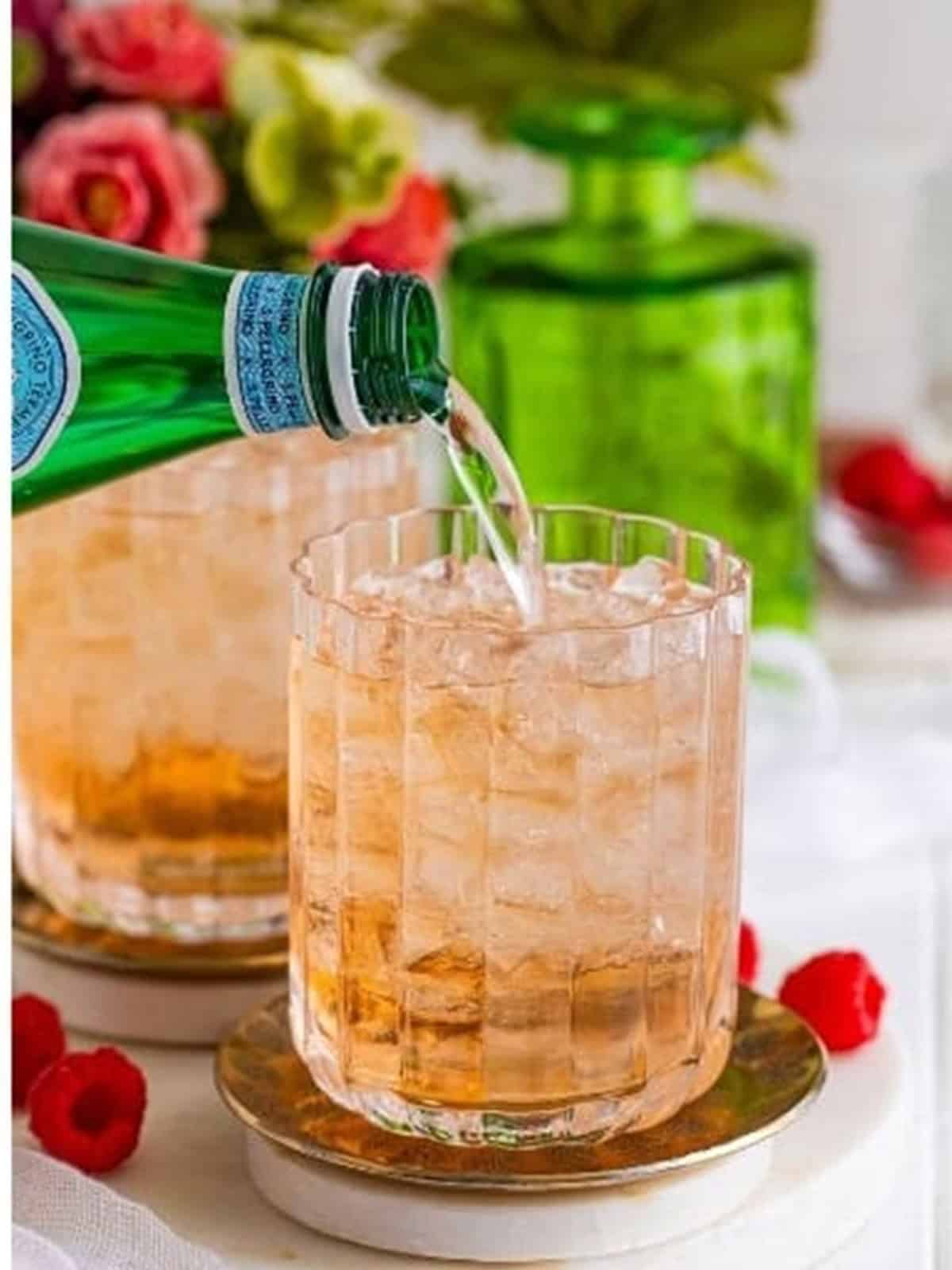 Sparkling water being added to top off a wine spritzer.