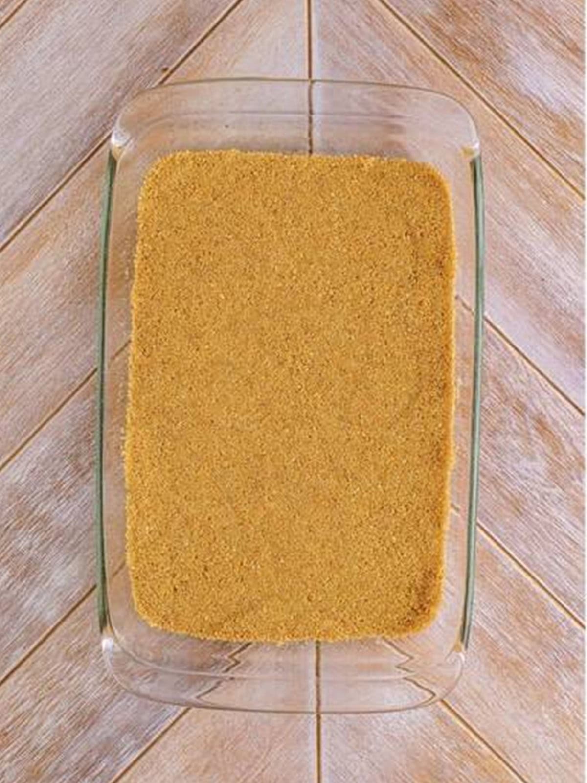 Graham cracker crust pressed into the bottom of a 9x13 baking dish for woolworth cheesecake recipe.