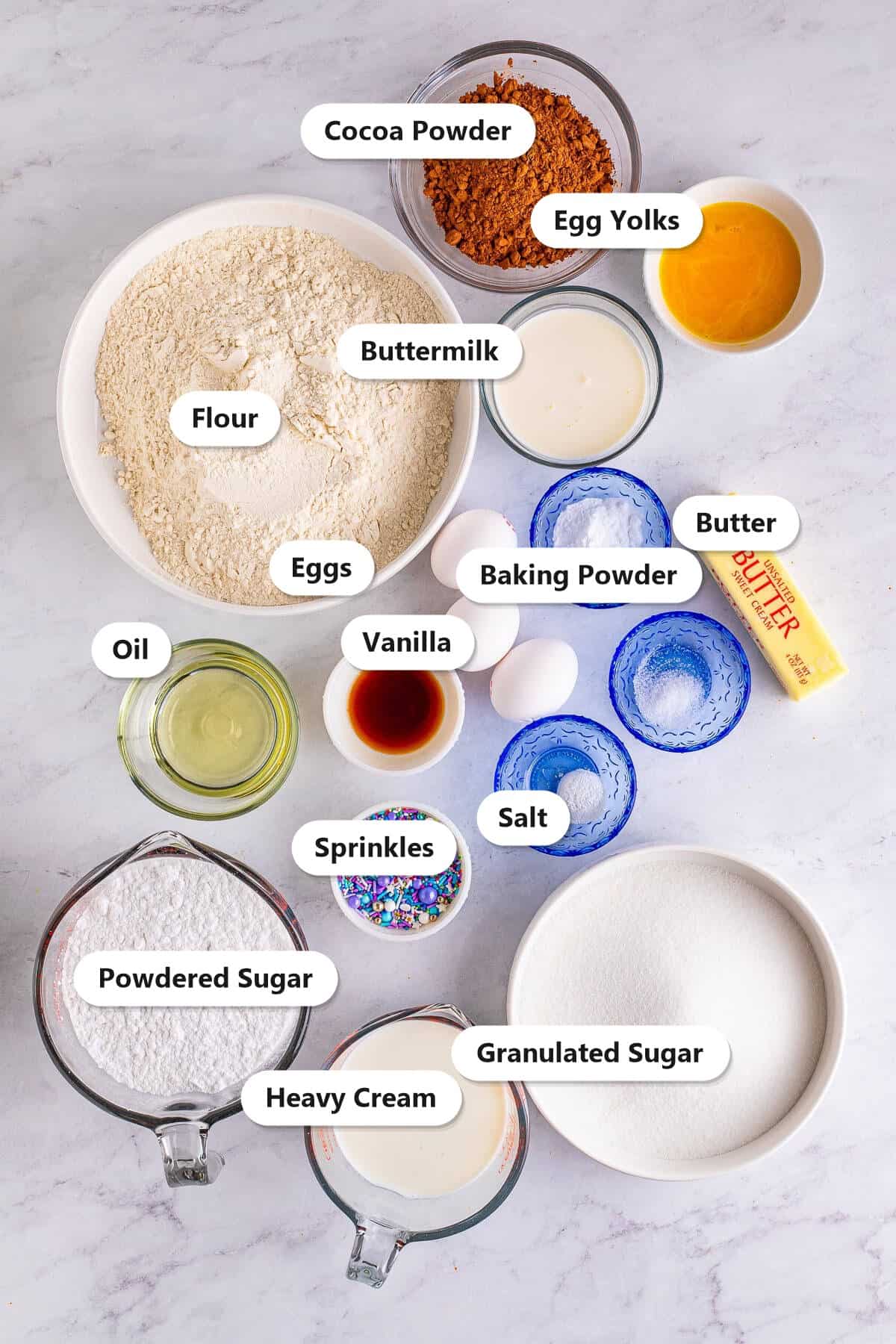 Labeled ingredients for Yellow Cake with Chocolate Frosting including flour, butter, eggs, and cocoa powder.