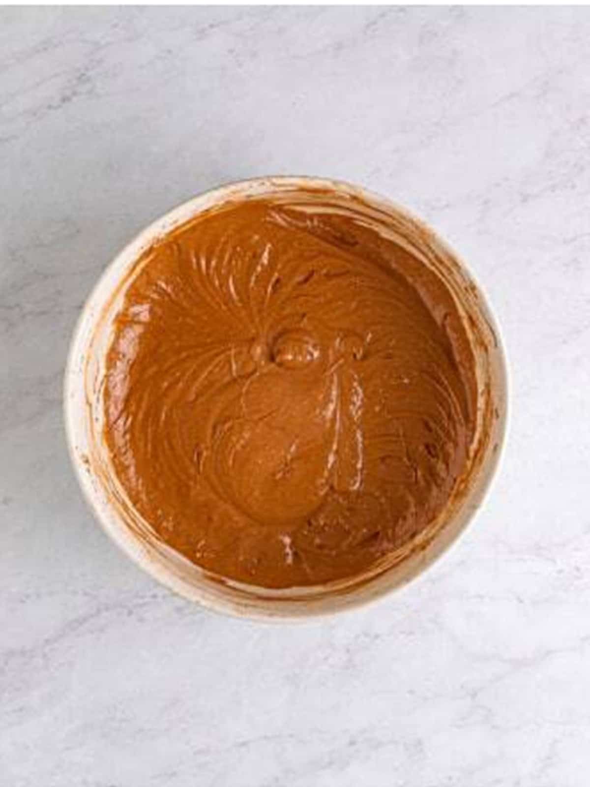 Chocolate cake batter made by stirring cocoa powder into half of the white cake batter.