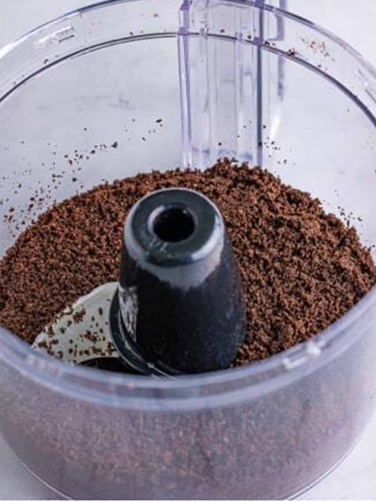 Oreos processed into fine crumbs in a food processor for the cookies and cream frosting.