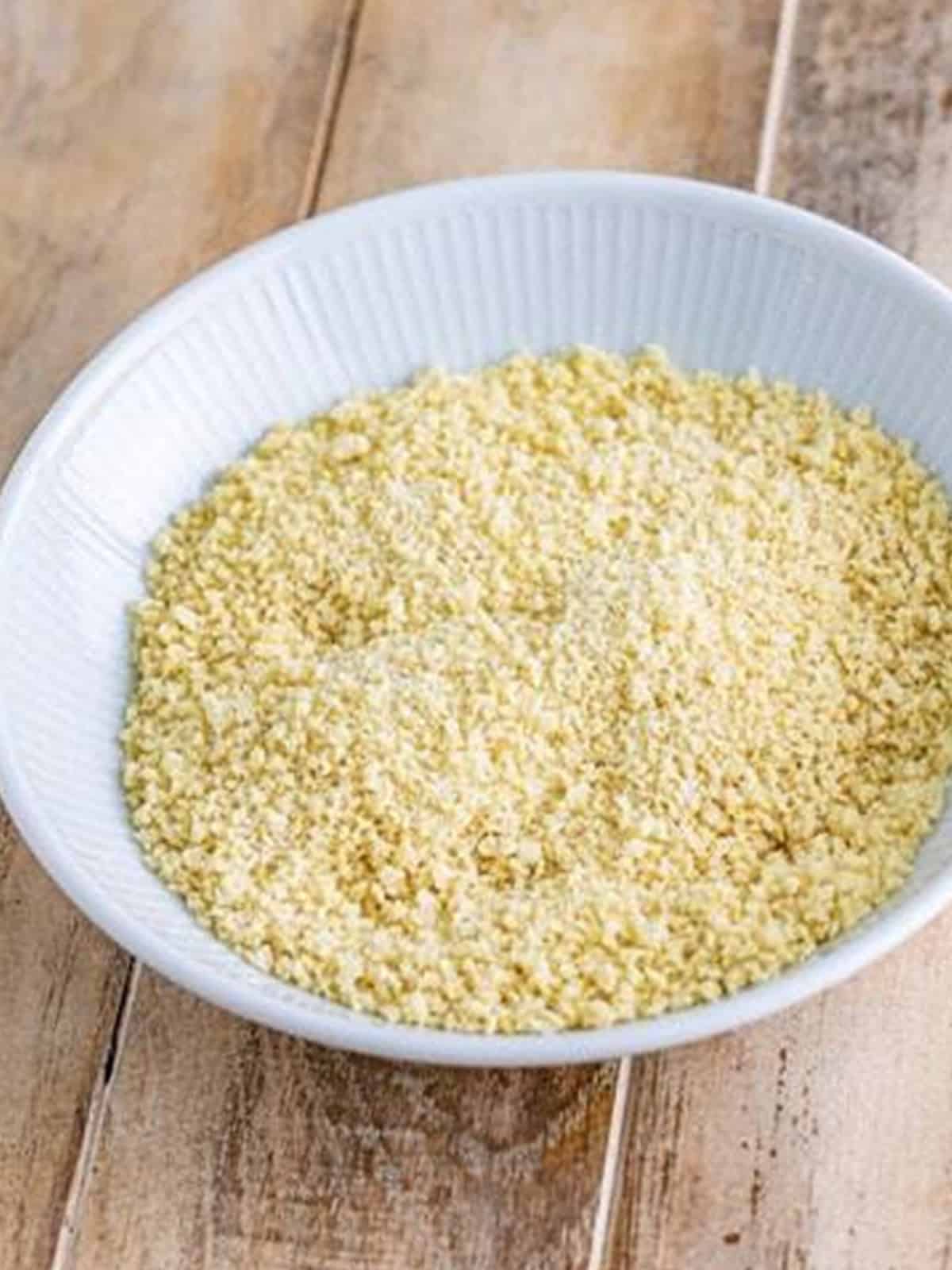 Panko breadcrumbs and grated parmesan combined in a white bowl.