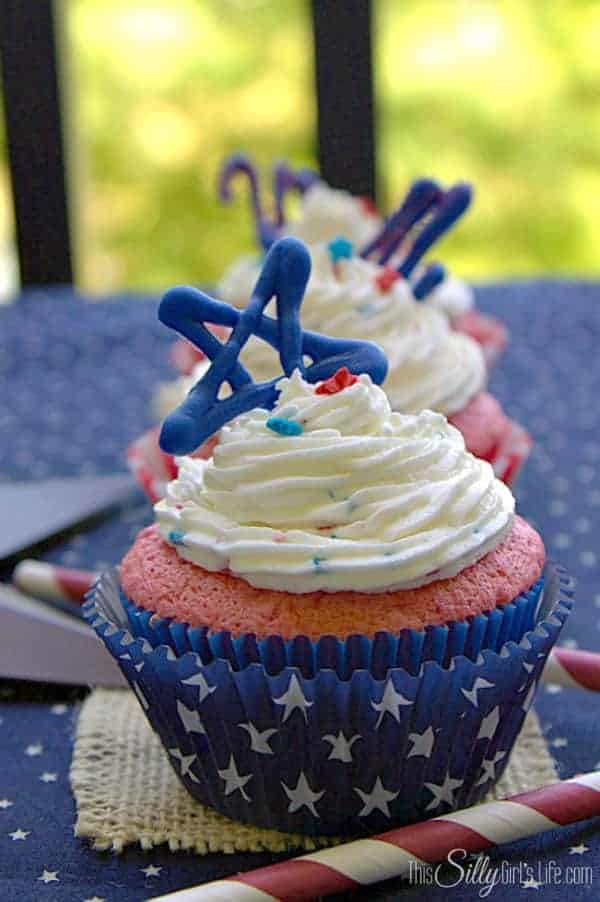 4th of July cupcake in a blue star liner topped with white funfetti frosting and a blue candy star.