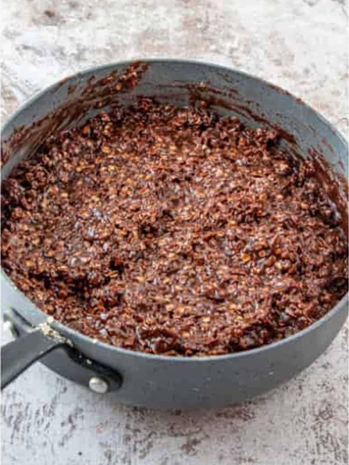Oats and coconut stirred until fully coated in the chocolate mixture
