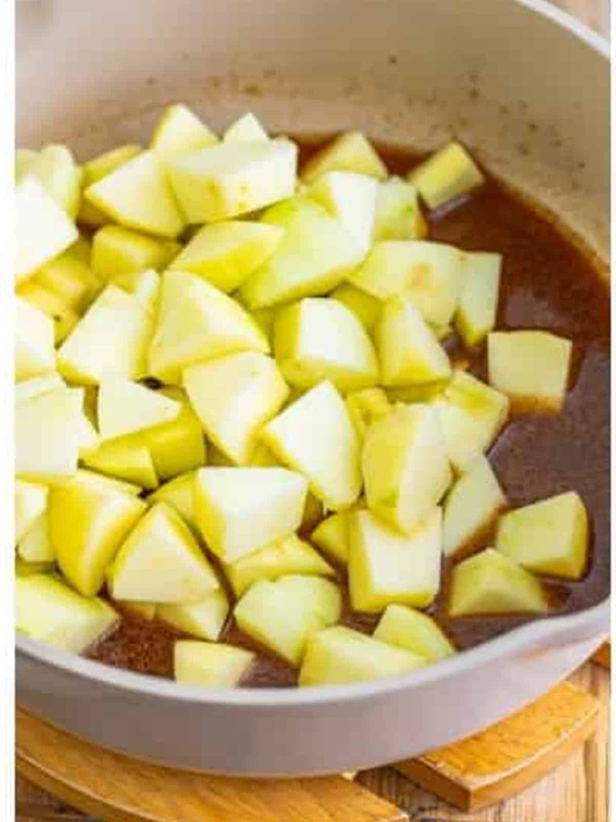 Diced Granny Smith apples added to the melted butter and brown sugar mixture.