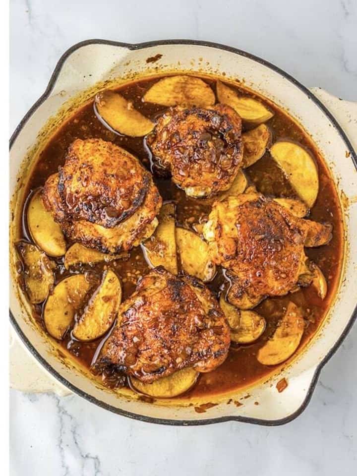 Seared chicken thighs and sliced apples back in the pan coated with cider glaze.