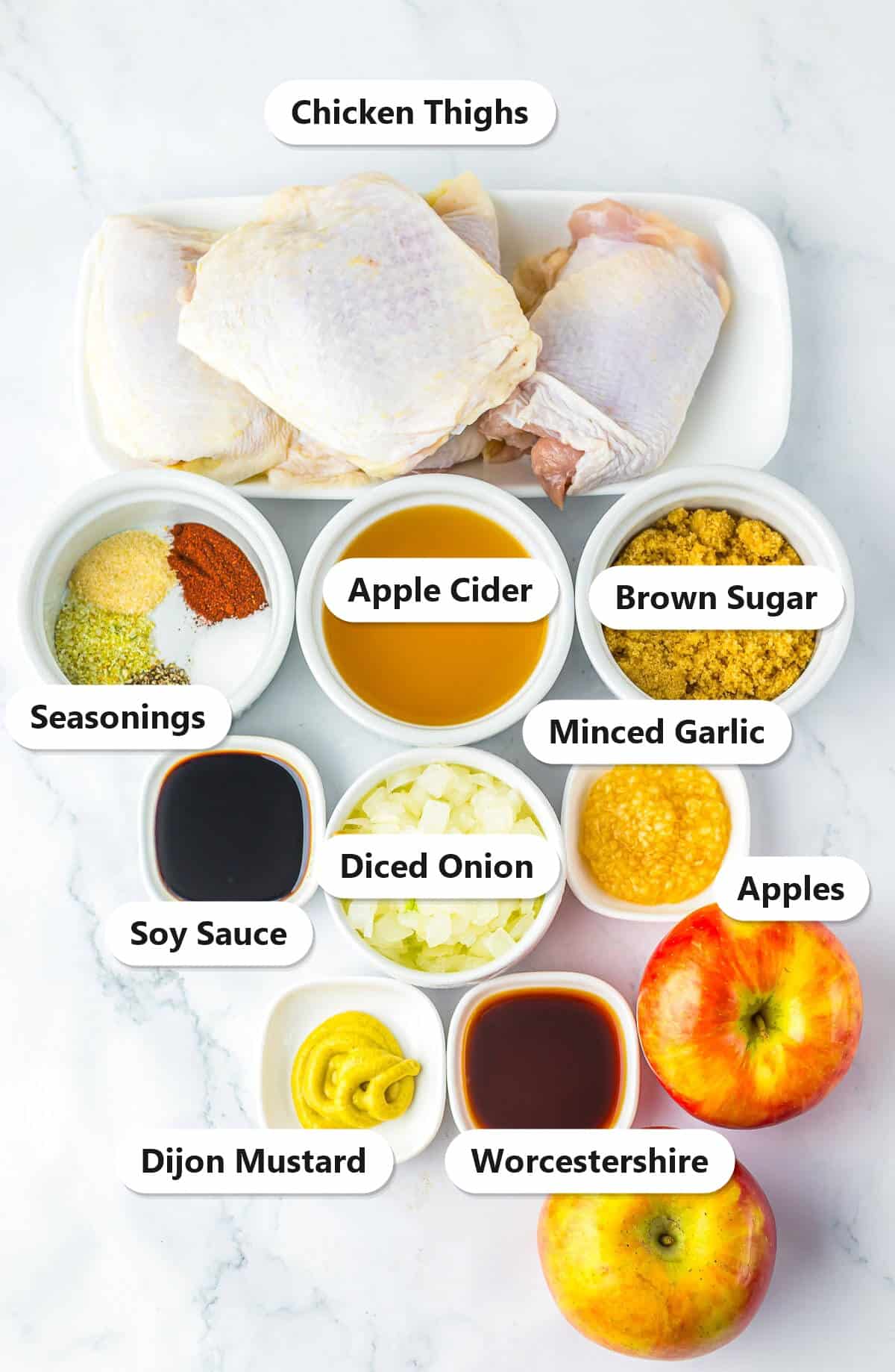Labeled ingredients for Apple Cider Chicken including chicken thighs, apple cider, brown sugar, apples, soy sauce, Dijon mustard, Worcestershire, garlic, onion, and seasonings.