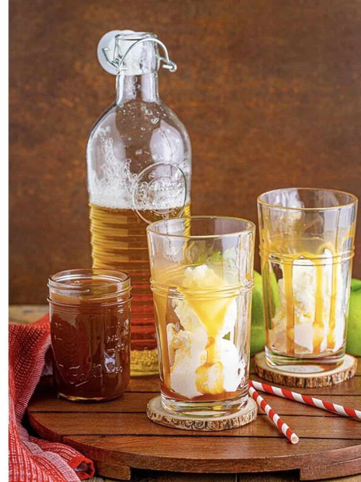 Scoops of vanilla ice cream added to the caramel drizzled glasses for an apple cider float.