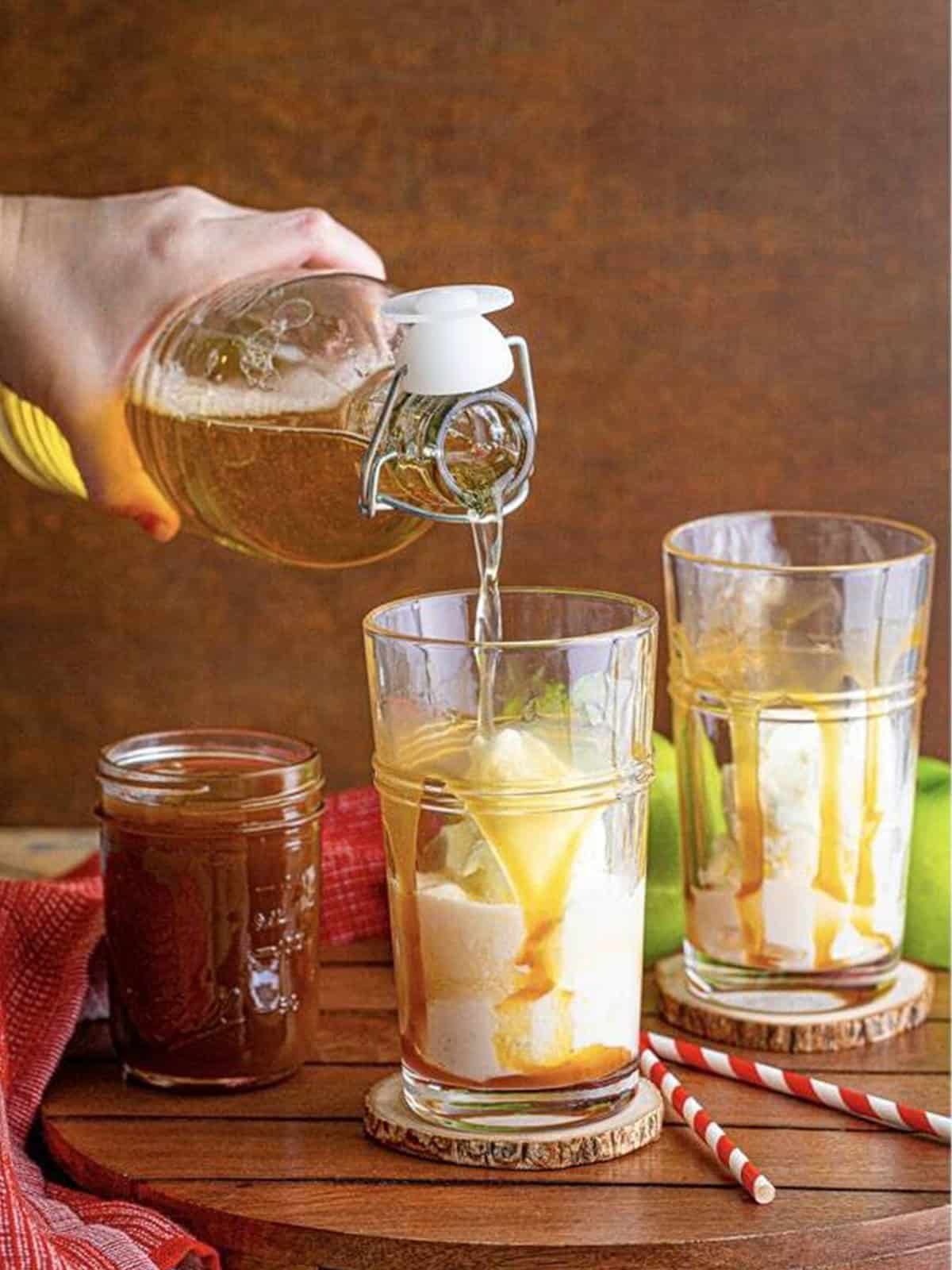 Sparkling apple cider poured over vanilla ice cream for an apple cider float.