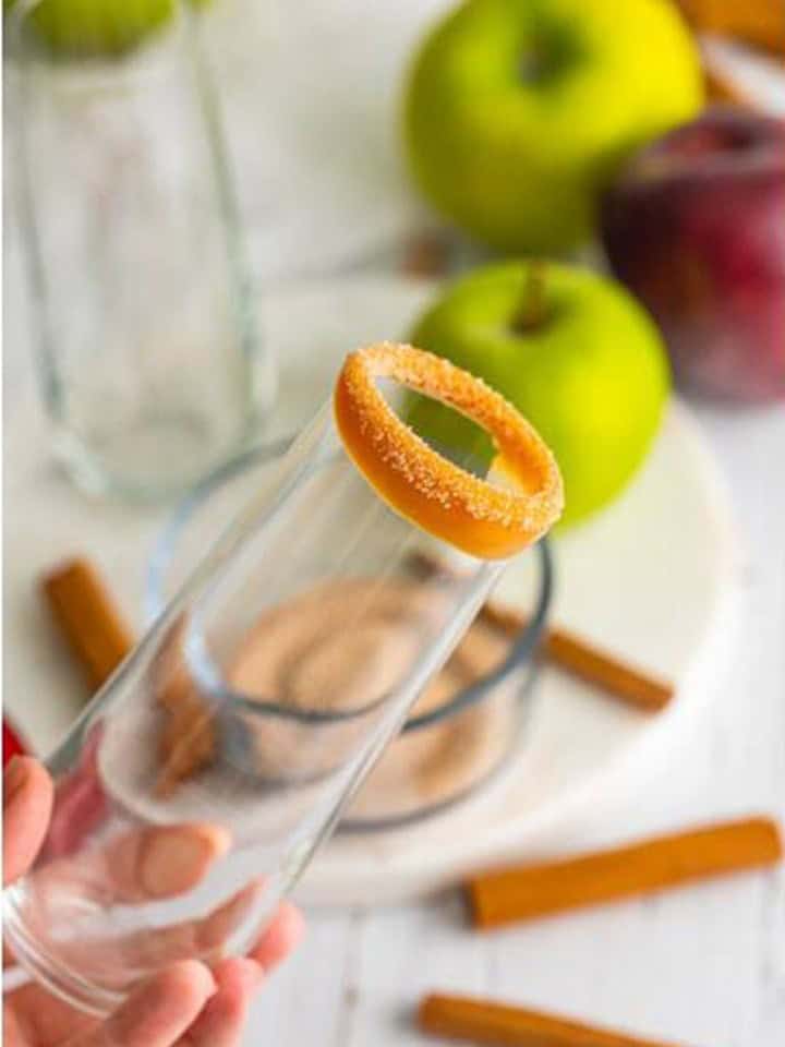 Champagne flute rimmed with caramel and cinnamon sugar for an apple cider mimosa.