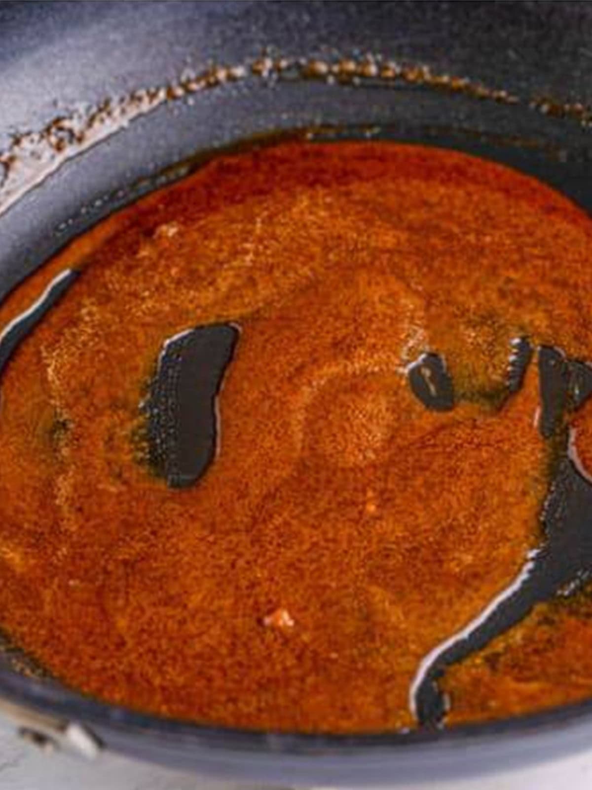 Butter, brown sugar, and cinnamon melted together in a skillet for Apple Hand Pies filling.